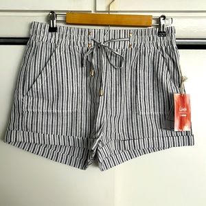 Striped white/blue shorts. Elastic waist and decorative front tie. 2” inseam.
